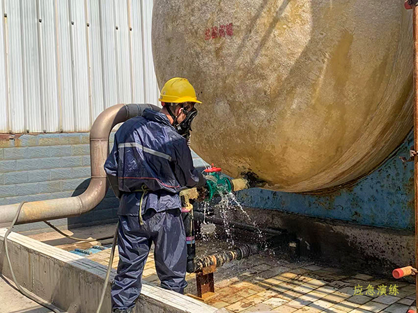 現(xiàn)場操作工對鹽酸泄漏處進行沖水處置   600.jpg